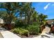 Scenic view of a walking path and tropical landscaping leading to buildings in a beautiful community on a sunny day at 625 30Th W Ave # G210, Bradenton, FL 34205