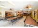 Large community room with a kitchen, tables, chairs, and a cozy lounge area for residents at 625 30Th W Ave # G210, Bradenton, FL 34205