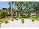 Landscaped courtyard features gravel and potted plants near condominium buildings at 625 30Th W Ave # G210, Bradenton, FL 34205