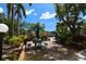 A view of the outdoor dining area from a deck overlooking luscious landscape at 625 30Th W Ave # G210, Bradenton, FL 34205
