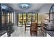 A dining room with a table and chairs next to the living area with a view out to a balcony at 625 30Th W Ave # G210, Bradenton, FL 34205