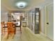 A dining room features a table, chairs, and china cabinet with an open concept view into the kitchen at 625 30Th W Ave # G210, Bradenton, FL 34205