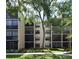External shot showcasing the condo building's architecture, multiple balconies, and well-maintained greenery at 625 30Th W Ave # G210, Bradenton, FL 34205