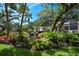 Beautiful landscaping features tropical plants, trees, and a small stream with a waterfall at 625 30Th W Ave # G210, Bradenton, FL 34205