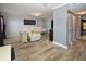 Spacious living room with stylish wood flooring, comfortable seating, and access to other areas of the home at 625 30Th W Ave # G210, Bradenton, FL 34205