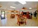 Bright clubhouse room with round tables, chairs, ceiling fans, and tile flooring offers versatile community space at 625 30Th W Ave # G210, Bradenton, FL 34205