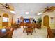 Clubhouse interior featuring tables, chairs, tile floor, and entertainment center, perfect for community events and activities at 625 30Th W Ave # G210, Bradenton, FL 34205