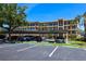 Parking lot with covered parking and condominium buildings at 625 30Th W Ave # G210, Bradenton, FL 34205