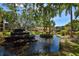 A pond with a fountain is surrounded by lush greenery in this park-like condominium community at 625 30Th W Ave # G210, Bradenton, FL 34205