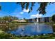 Scenic view of pond and fountain with swans, community buildings, and lush landscaping create a serene community setting at 625 30Th W Ave # G210, Bradenton, FL 34205