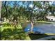 Scenic view of a community pond with a fountain, benches, and lush greenery at 625 30Th W Ave # G210, Bradenton, FL 34205