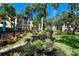 Scenic view of lush community landscaping, water features, and condominium buildings at 625 30Th W Ave # G210, Bradenton, FL 34205