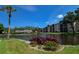 Picturesque view of the pond with fountain, community buildings, and lush landscaping create a serene community setting at 625 30Th W Ave # G210, Bradenton, FL 34205
