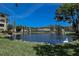 Beautiful pond view showcasing a well-maintained complex with lush landscaping, fountain, and elegant swan decor at 625 30Th W Ave # G210, Bradenton, FL 34205
