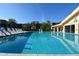 Relaxing pool area with sun loungers, building and blue sunny sky at 625 30Th W Ave # G210, Bradenton, FL 34205