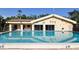 Community swimming pool with decorative pool house, clear blue water and marked depths at 625 30Th W Ave # G210, Bradenton, FL 34205