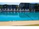 A clear, bright swimming pool with a safety line and chairs surrounding the perimeter at 625 30Th W Ave # G210, Bradenton, FL 34205