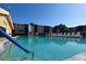 Community pool with clear blue water, condos in the background, and lounge chairs nearby at 625 30Th W Ave # G210, Bradenton, FL 34205