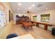 Community recreation room with billiards table, large windows, bookshelf and wood flooring at 625 30Th W Ave # G210, Bradenton, FL 34205
