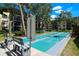 A shuffleboard court and bench seating surrounded by lush landscaping with community buildings in background at 625 30Th W Ave # G210, Bradenton, FL 34205