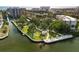 Aerial view of waterfront property with mature trees, landscaping and seating at 6415 Midnight Pass Rd # 204, Sarasota, FL 34242