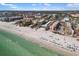 Stunning aerial view of beachfront condos along the white sand beach and the Gulf at 6415 Midnight Pass Rd # 204, Sarasota, FL 34242