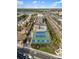 Aerial view of complex featuring tennis courts, swimming pool, and lovely landscaping and surrounding buildings at 6415 Midnight Pass Rd # 204, Sarasota, FL 34242