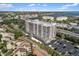 Stunning aerial view of waterfront condo building with pool and surrounding community at 6415 Midnight Pass Rd # 204, Sarasota, FL 34242