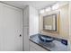 Bathroom with granite countertop, black vessel sink, framed mirror and ample cabinet storage at 6415 Midnight Pass Rd # 204, Sarasota, FL 34242