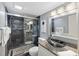 Modern bathroom featuring a glass-enclosed shower with mosaic tiles and granite countertop sink at 6415 Midnight Pass Rd # 204, Sarasota, FL 34242