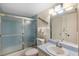 Clean bathroom with a glass-enclosed shower, vanity and classic fixtures at 6415 Midnight Pass Rd # 204, Sarasota, FL 34242