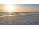 The beach at sunset with gentle waves lapping the shore in this tranquil coastal scene at 6415 Midnight Pass Rd # 204, Sarasota, FL 34242