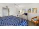 Cozy bedroom with dual beds, complemented by beach-themed wall art and ample natural light at 6415 Midnight Pass Rd # 204, Sarasota, FL 34242