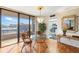 Dining area with a chandelier, access to the balcony, and an adjacent well-equipped kitchen at 6415 Midnight Pass Rd # 204, Sarasota, FL 34242