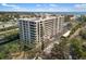 Exterior view of the building showing multiple units with balconies and lush landscaping at 6415 Midnight Pass Rd # 204, Sarasota, FL 34242