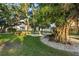 Scenic green space with lush trees, benches, and a charming pathway, perfect for relaxation and leisurely strolls at 6415 Midnight Pass Rd # 204, Sarasota, FL 34242