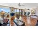 Living room with sliding glass doors to balcony, a ceiling fan, and views of the kitchen at 6415 Midnight Pass Rd # 204, Sarasota, FL 34242