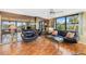 Bright living room features a large window with great views, stylish furniture, and mirrored wall at 6415 Midnight Pass Rd # 204, Sarasota, FL 34242