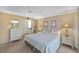 Bright main bedroom featuring carpeted floors, a closet, and two bedside tables with lamps at 6415 Midnight Pass Rd # 204, Sarasota, FL 34242