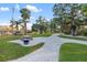 Park featuring a manicured lawn, palm trees and picnic tables at 6415 Midnight Pass Rd # 204, Sarasota, FL 34242