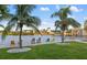 Park view with palm trees, chairs, grass, and a water view at 6415 Midnight Pass Rd # 204, Sarasota, FL 34242