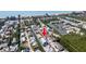 Discover the blue canal-front home from an aerial shot highlighting the waterside neighborhood and beach access at 654 Jungle Queen Way, Longboat Key, FL 34228