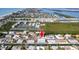 See this two-story blue home on a canal from above, in a coastal community near the beach at 654 Jungle Queen Way, Longboat Key, FL 34228