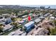 An aerial view showcases a blue two-story home on a canal, offering a private dock at 654 Jungle Queen Way, Longboat Key, FL 34228