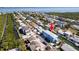 Enjoy waterfront living with an aerial view of the charming blue home nestled along a serene canal at 654 Jungle Queen Way, Longboat Key, FL 34228