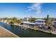 Aerial shot of waterfront homes along a canal, showing docks and boat lifts on a sunny day at 654 Jungle Queen Way, Longboat Key, FL 34228