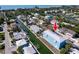 Aerial view of a modern blue two-story home located on a canal with boat dock at 654 Jungle Queen Way, Longboat Key, FL 34228