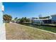 Backyard overlooking a canal, with waterfront views, dock access, and grassy area for outdoor activities at 654 Jungle Queen Way, Longboat Key, FL 34228