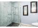 Bathroom featuring a glass door shower, gray marble walls, and a mosaic tile inset in the shower wall at 654 Jungle Queen Way, Longboat Key, FL 34228