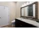 Bathroom featuring granite vanity countertop, large mirror, and natural light at 654 Jungle Queen Way, Longboat Key, FL 34228